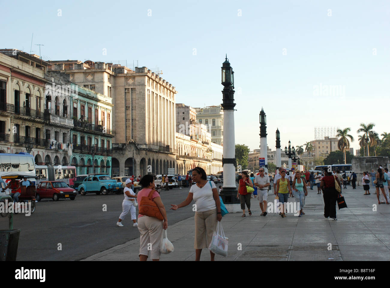 Cubans and tourists on street leading to the Capitol Parque Central on Boulevard Paseo de Marti square by Capitol Havana Cuba Stock Photo