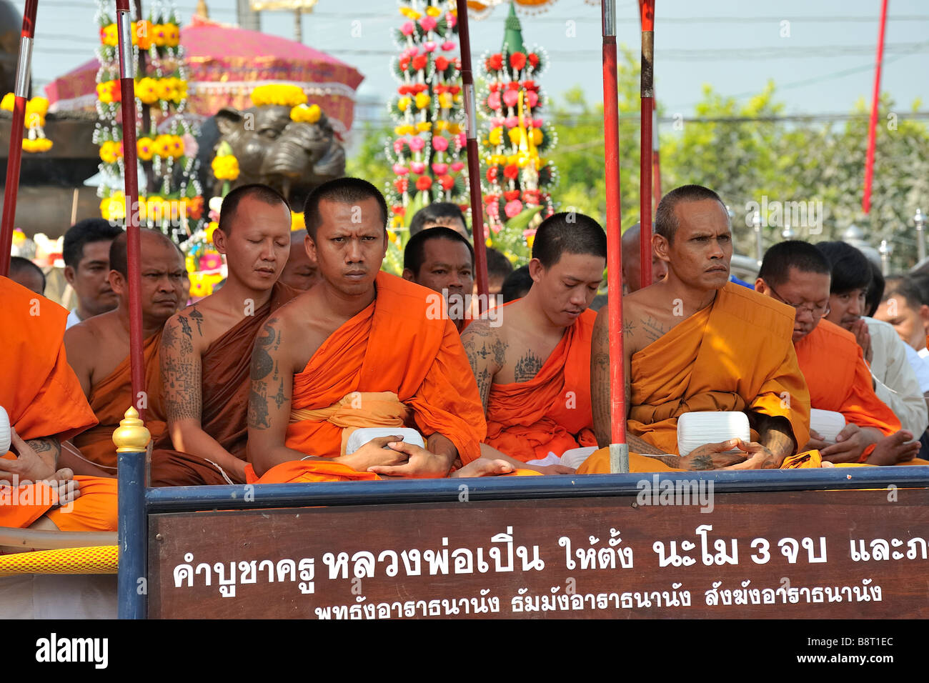 Monks with sacred Sak Yant tattoos at tattoo festival at Wat Bang Phra temple, Nakhon Chai Si, Thailand. Stock Photo