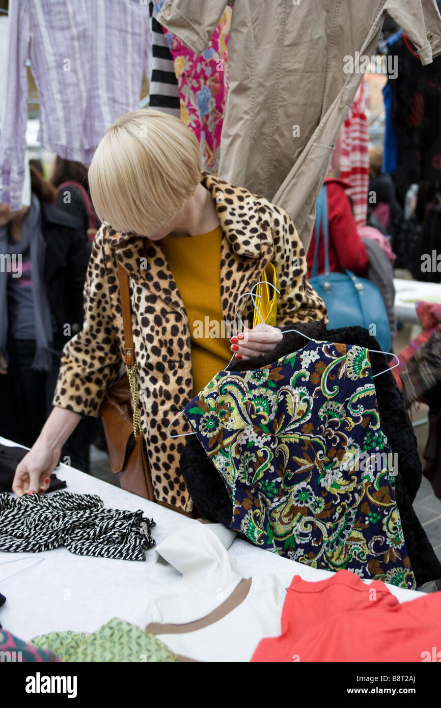 Clothes swapping event in London,Spitalfields Market.People swap their clothes for free for a new addition to their wardrobe. Stock Photo