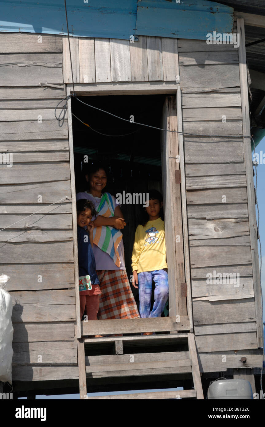 Suluk mother and children in doorway of wooden house Semporna Sulu Sea Malaysia South east Asia Stock Photo