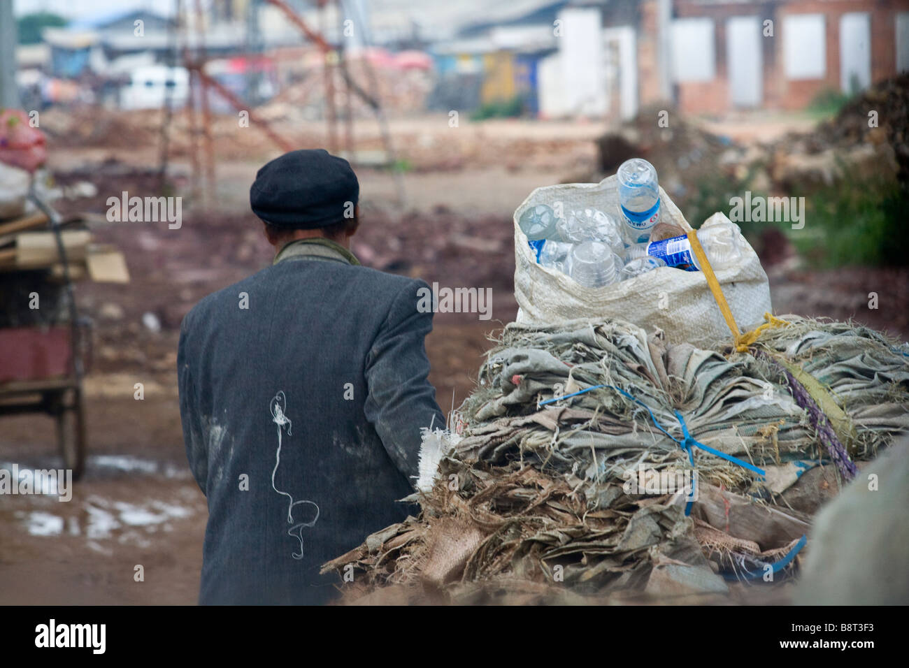 A trash collector pulling his cart in the suburbs of Kunming, Yunnan province, China. Stock Photo