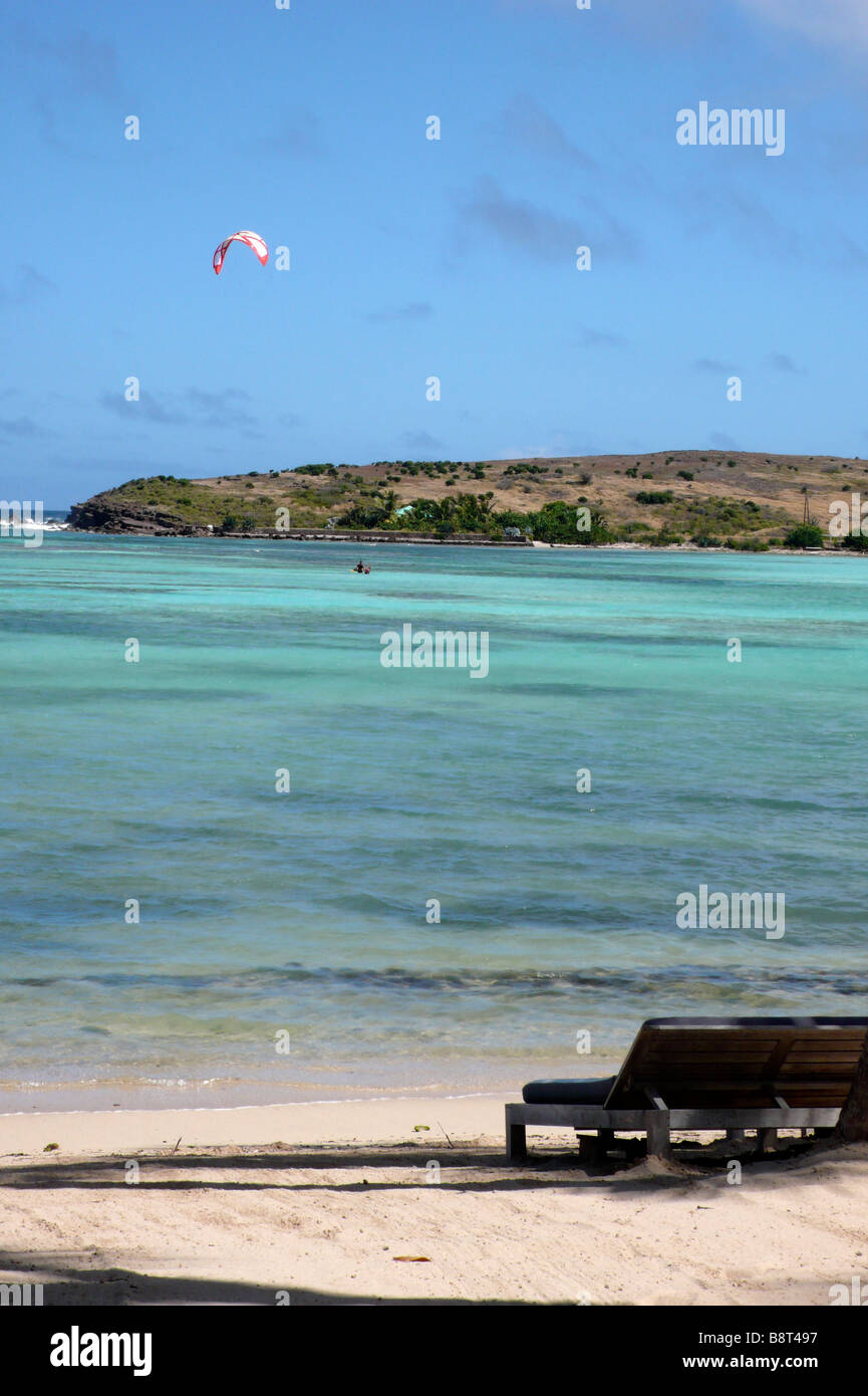 Sun beds on beach with kite surfer in background Stock Photo Alamy