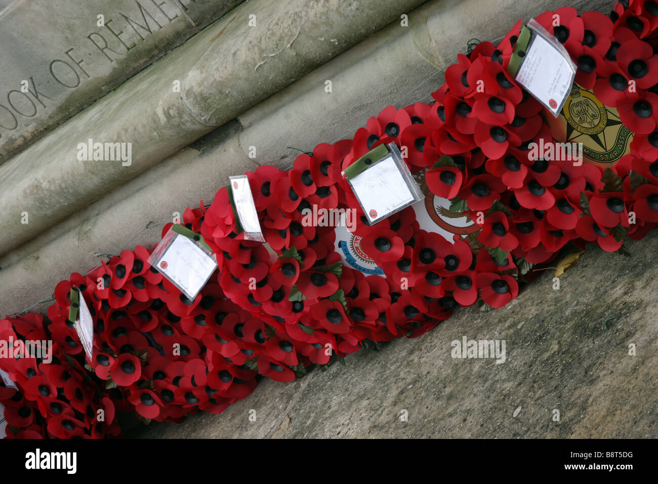 remembrance day poppy wreaths in a line at a war memorial Stock Photo ...