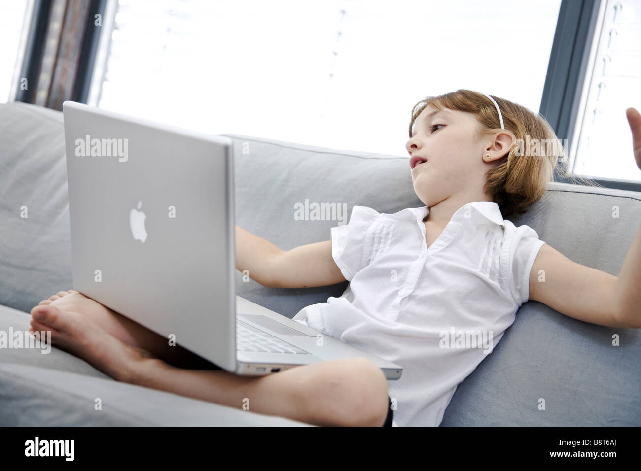 Girls sits on sofa hi-res stock photography and images - Alamy
