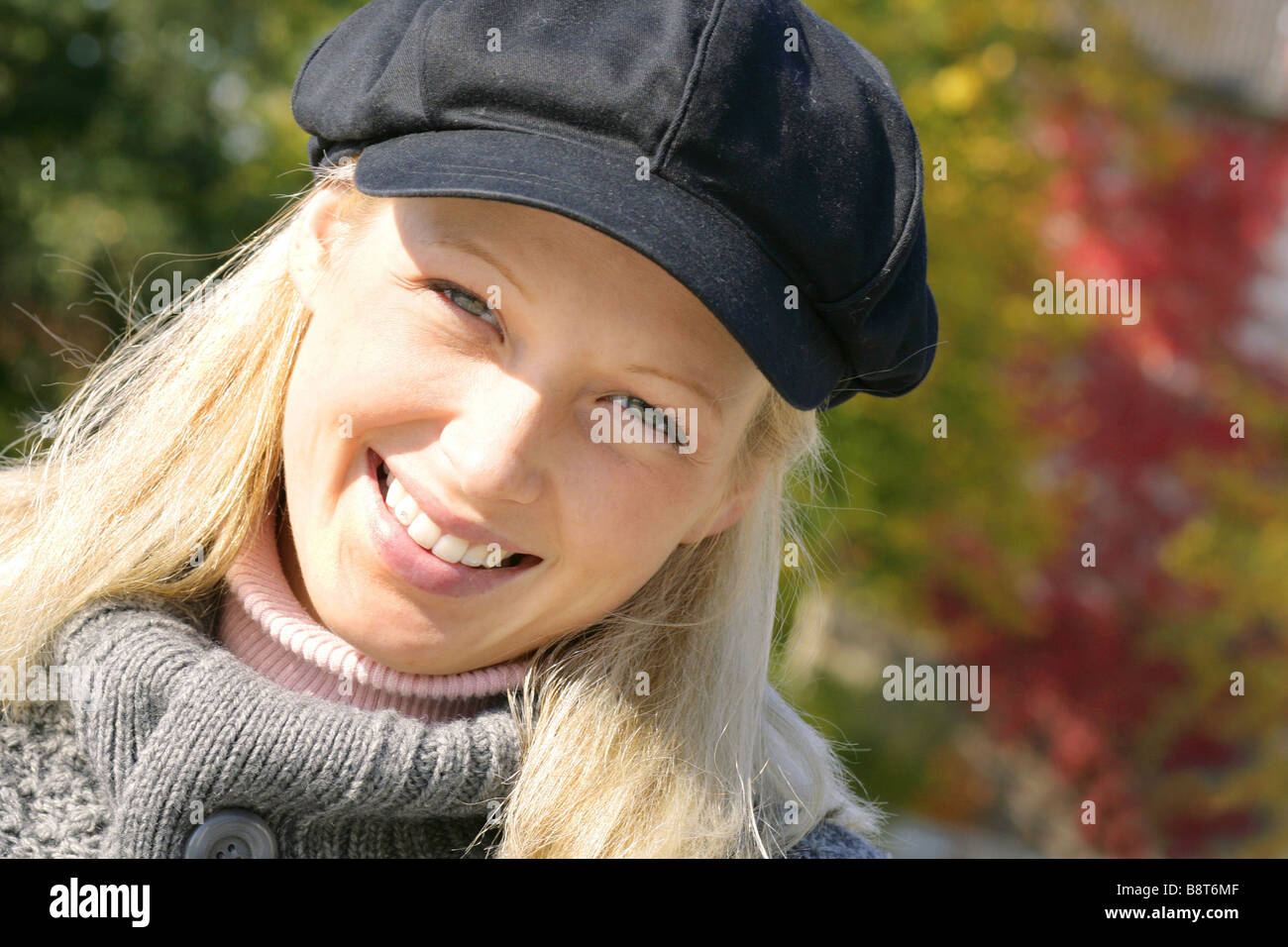 young blond girl with cap, smiling Stock Photo