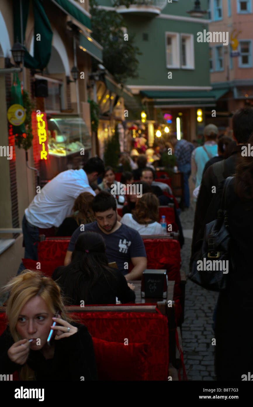 Young turks in a sidewalk café in Ortakoy neighborhood, Istanbul. Stock Photo