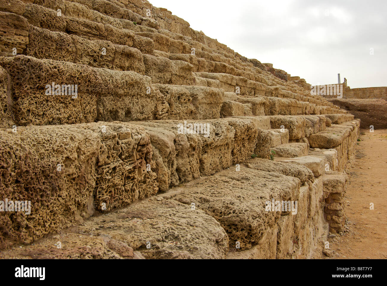 Ruins of worn stone seating of giant 10000 seat seaside Chariot racing hippodrome arena in King Herod built port Caesarea Stock Photo