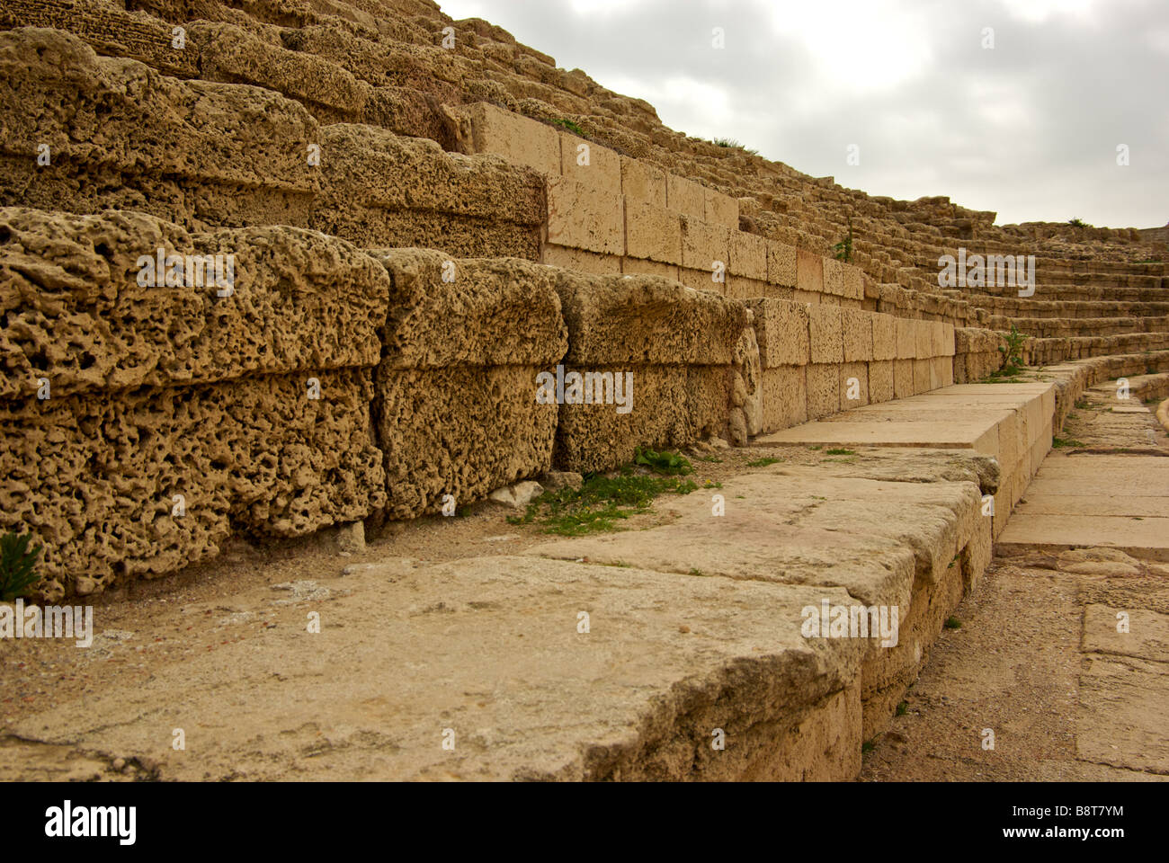 Ruins of worn stone seating of giant seaside Chariot racing hippodrome arena in King Herod built port Caesarea Stock Photo