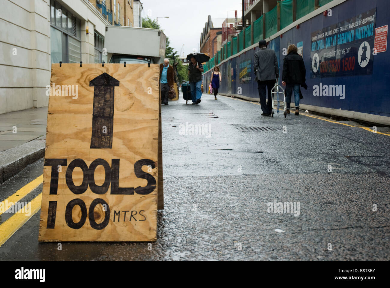 A hand painted sign advertises tools for sale in Brick Lane in East London, UK. Stock Photo