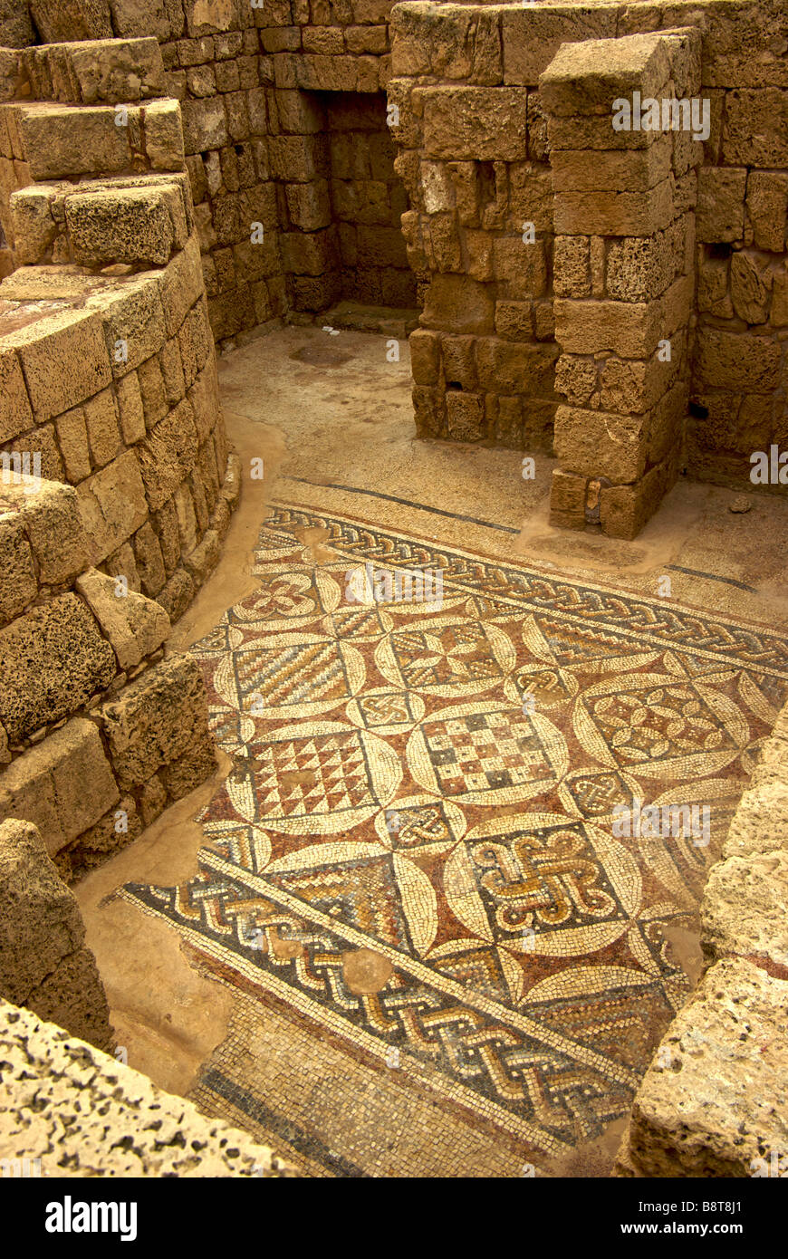 Geometric figure design tile floor mosaic in ruins of house room in King Herod built port city Caesarea Stock Photo