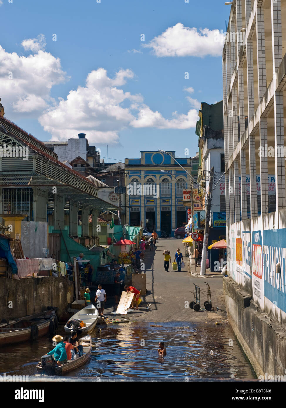 Man bathing in the Amazon river water next to the Mercado Municipal