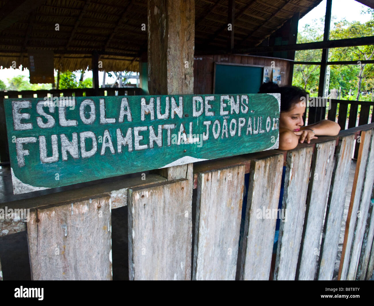 A young mother waiting in an empty schoolhouse in the Amazon. Jamaraquá, floresta do Tapajos, Para state, Brazil. Stock Photo