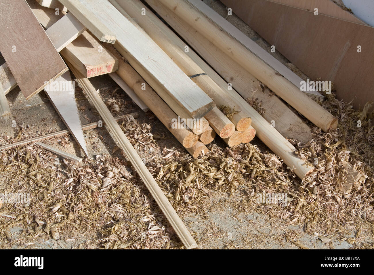 Some lengths of cut wood, on the floor, surrounded by woodshavings