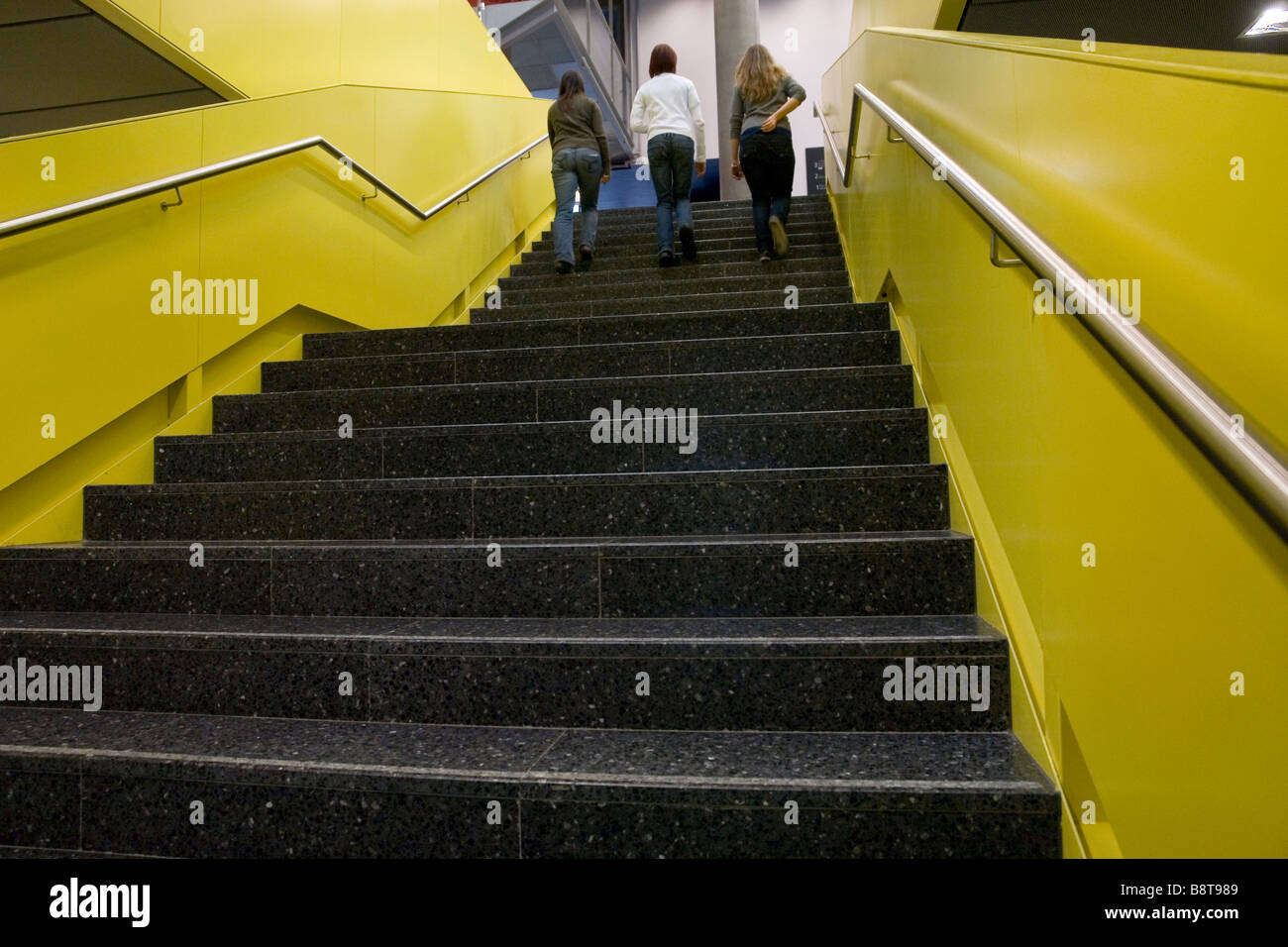 3 girls going up the stairs - Ars Electronica Museum - Linz - Austria Stock Photo