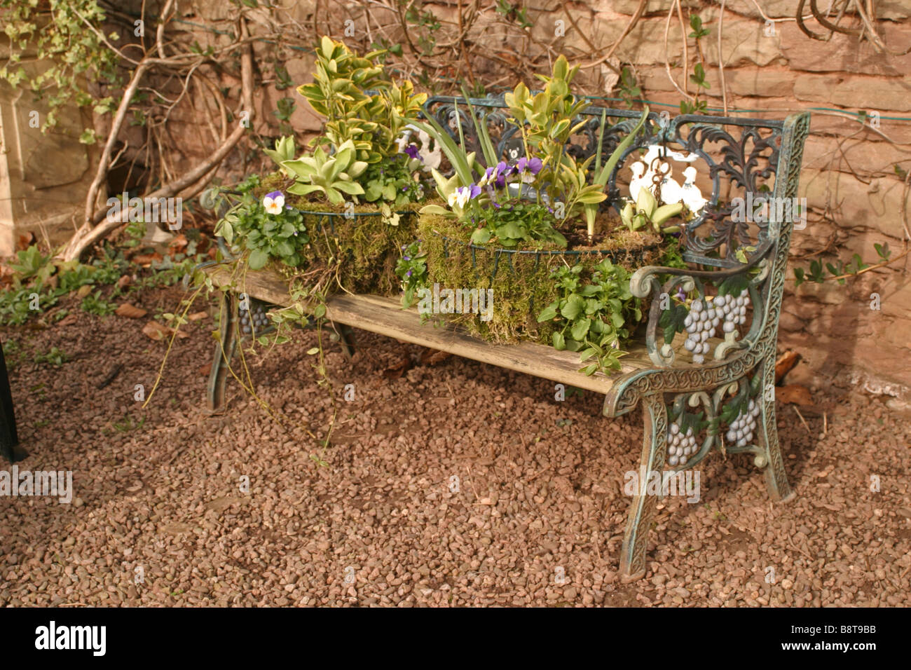 Garden Bench with hanging baskets Stock Photo Alamy