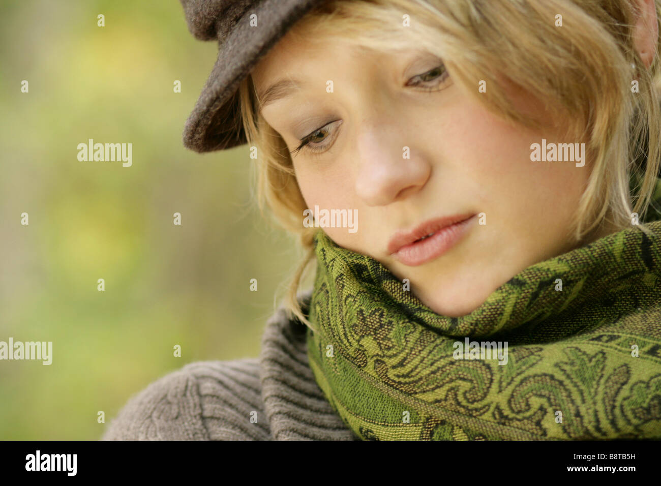 young blond dreamy girl with cap Stock Photo
