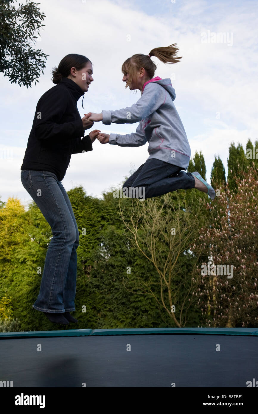 Two girls on a trampoline hi-res stock photography and images - Alamy