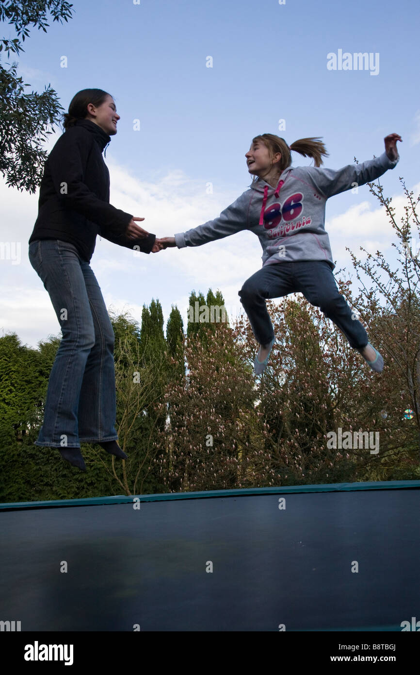 Two girls on a trampoline hi-res stock photography and images - Alamy