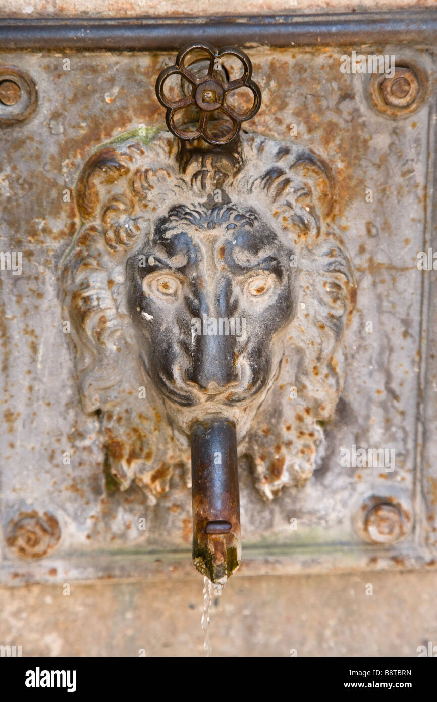 Decorative lion plaque drinking fountain in the old hill town of Volterra, Tuscany, Italy. Stock Photo