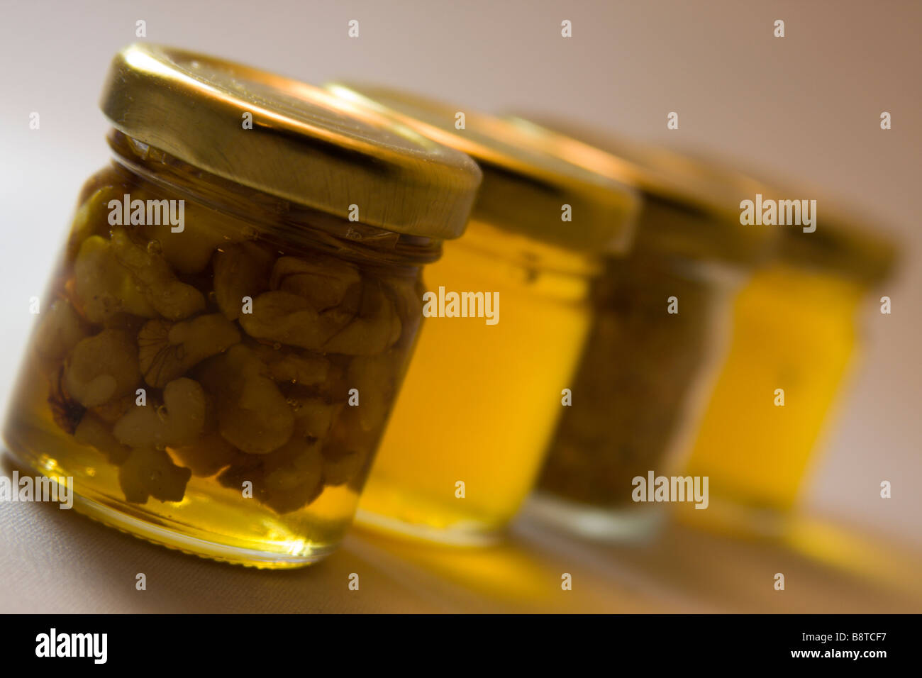Small jars of honey with nuts. Stock Photo