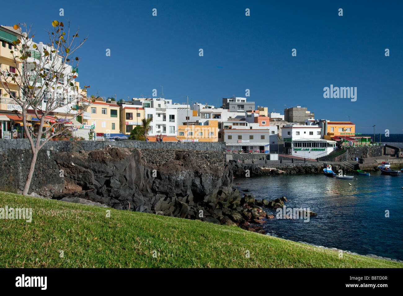 Late afternoon sunlight illuminates Los Abrigos village harbour in ...