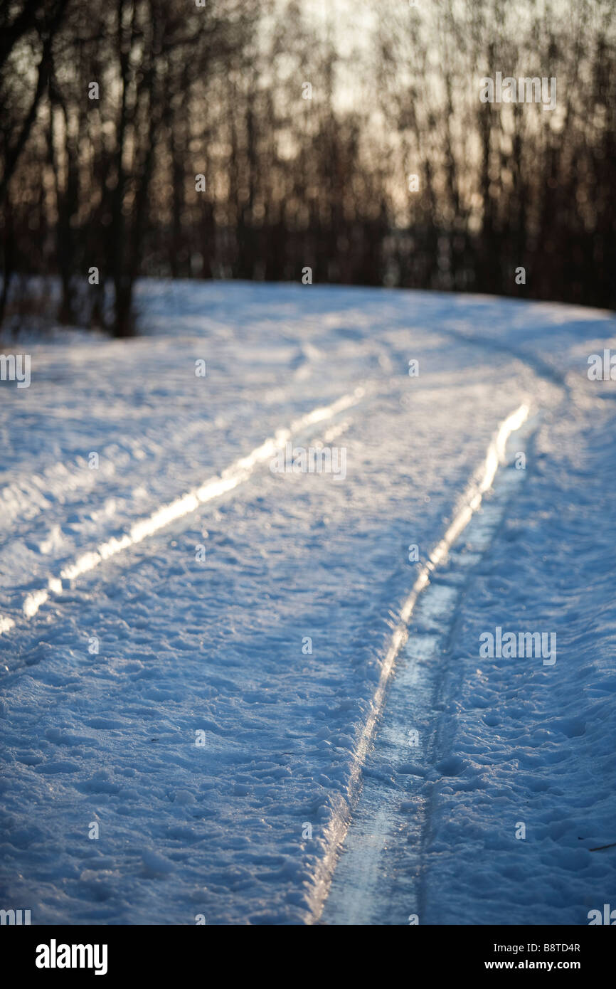 Frozen car tracks on icy and snowy by-road , Finland Stock Photo