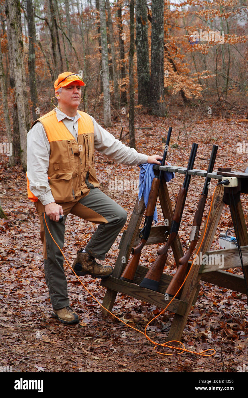 SPORTING CLAY SHOOTER OPERATING ELECTRIC SKEET RELEASE OUTDOOR