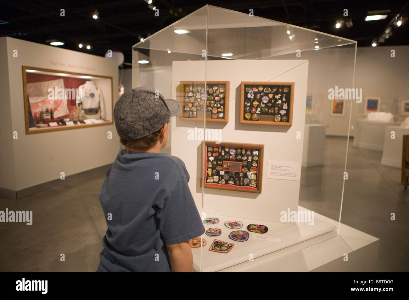 nine year old boy looking at collection of pins in a museum exhibit Stock Photo