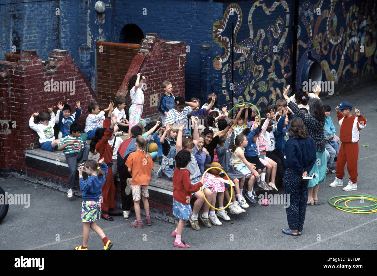 group of primary school children in the playground with teachers on summer sports day event Stock Photo