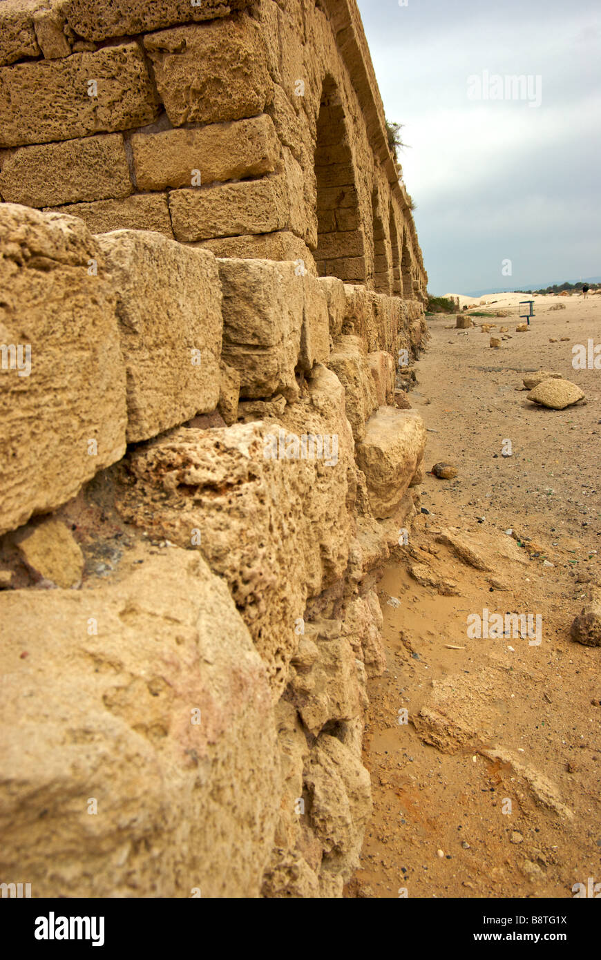 Remains of stone arch supported aqueduct that King Herod constructed to bring water from Mount Carvel to port city Caesarea Stock Photo