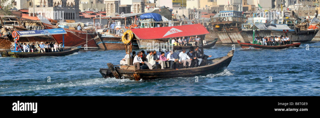 Dubai Creek traditional Abras water taxis and passengers Stock Photo