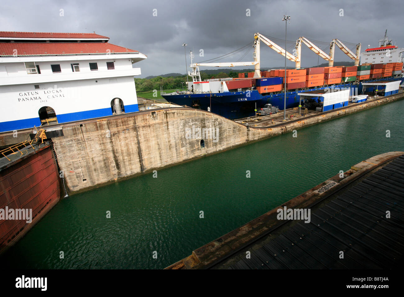 The Panama Canal locks (Spanish: Esclusas del Canal de Panamá) are a lock system that lifts a ship up 85 feet (26 m.) to the main elevation. Galun. Stock Photo