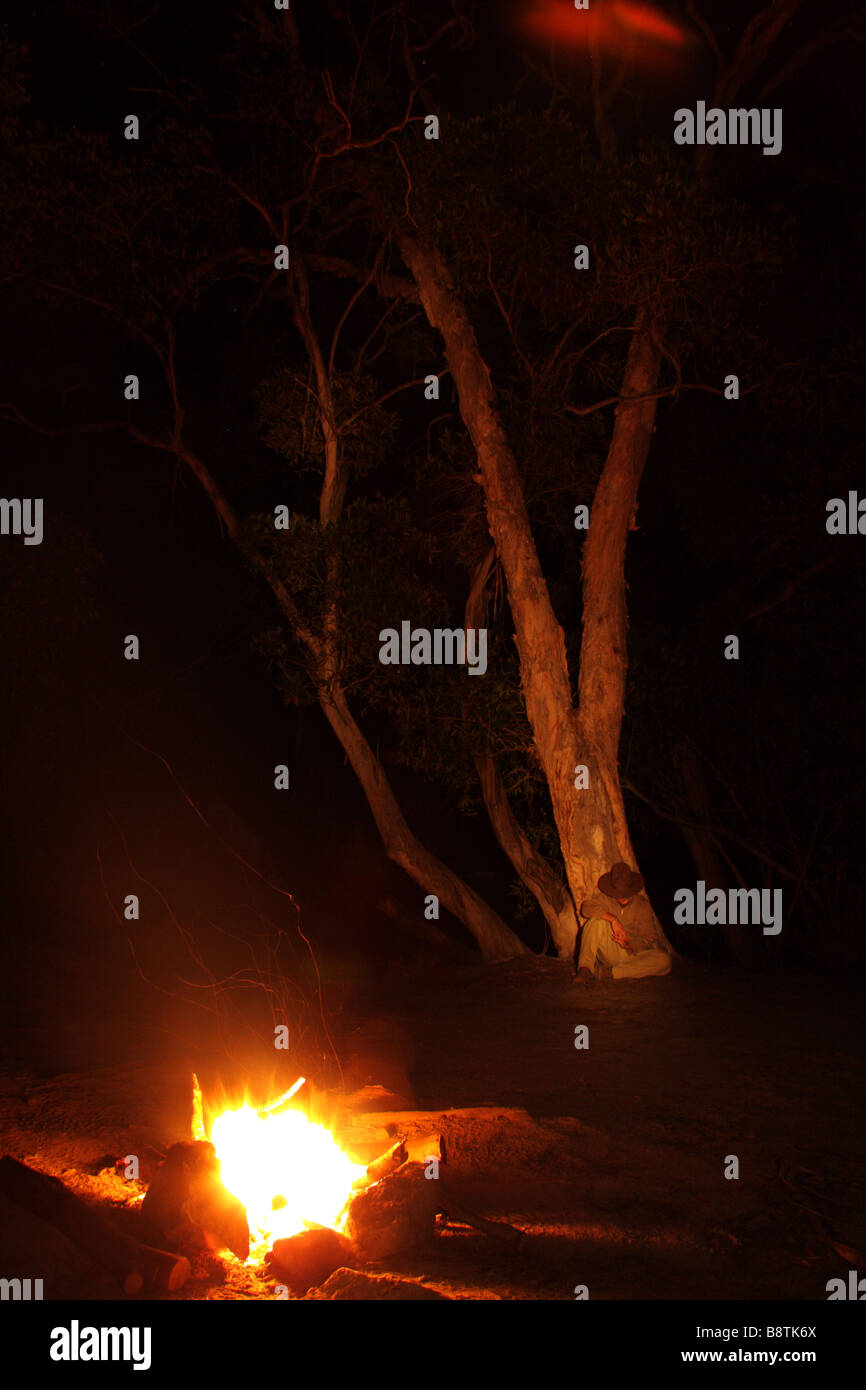 Man sitting by Campfire Stock Photo