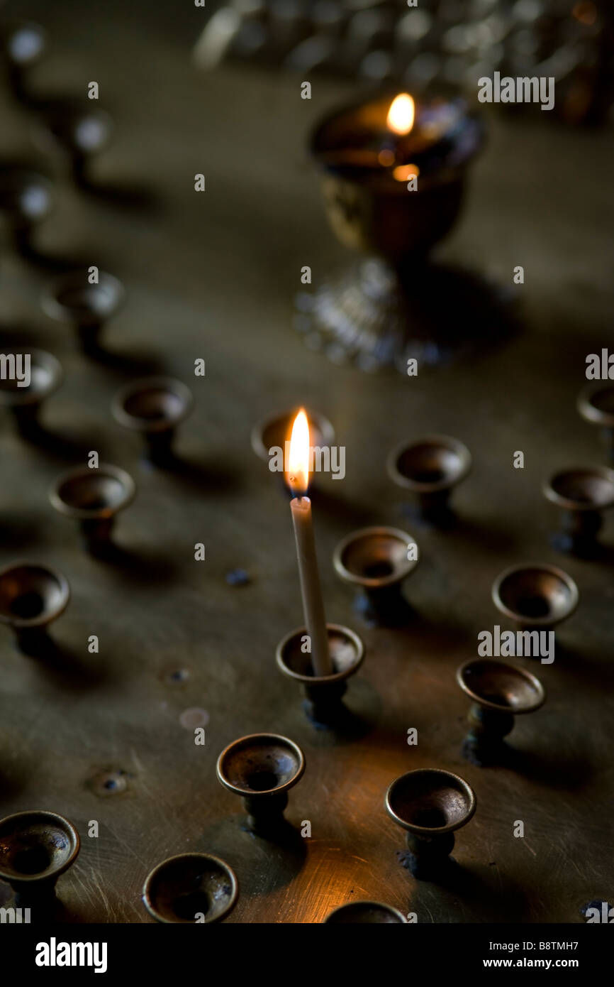 Burning votive candle on Altar. Shallow focus. Russian Orthodox church in Almaty, Kazakhstan. Stock Photo