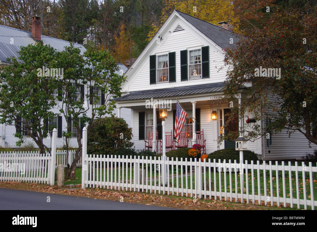 White clapboard house with a white picket fence Stock Photo