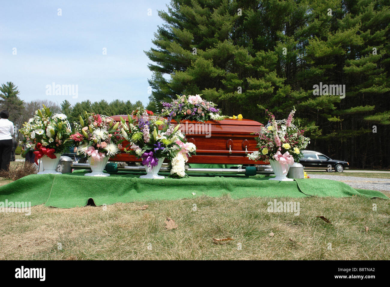 Wooden Casket and Flowers in a Cemetery Copy Space Stock Photo