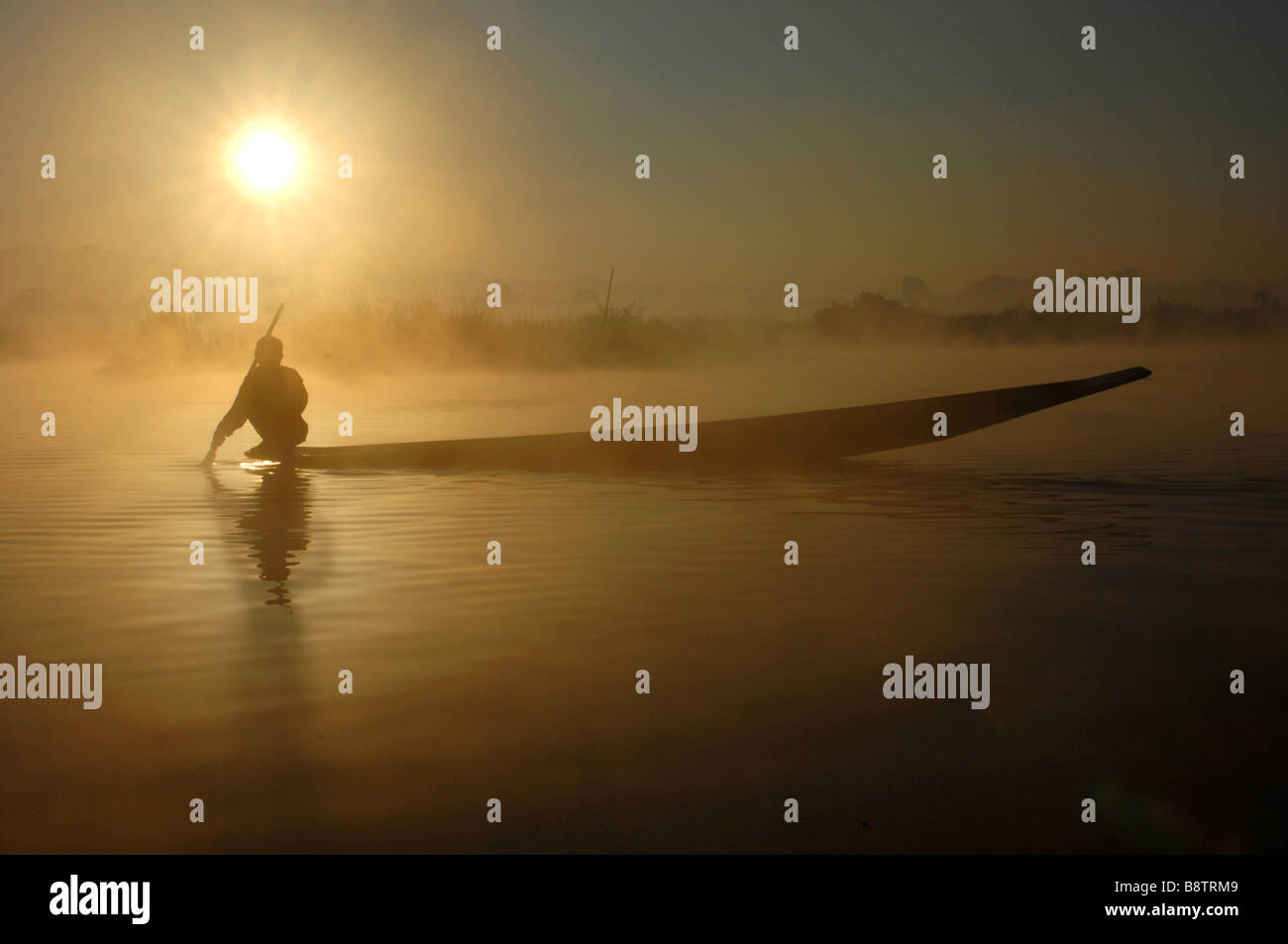 Fisherman in boat on lake with fog hi-res stock photography and images ...