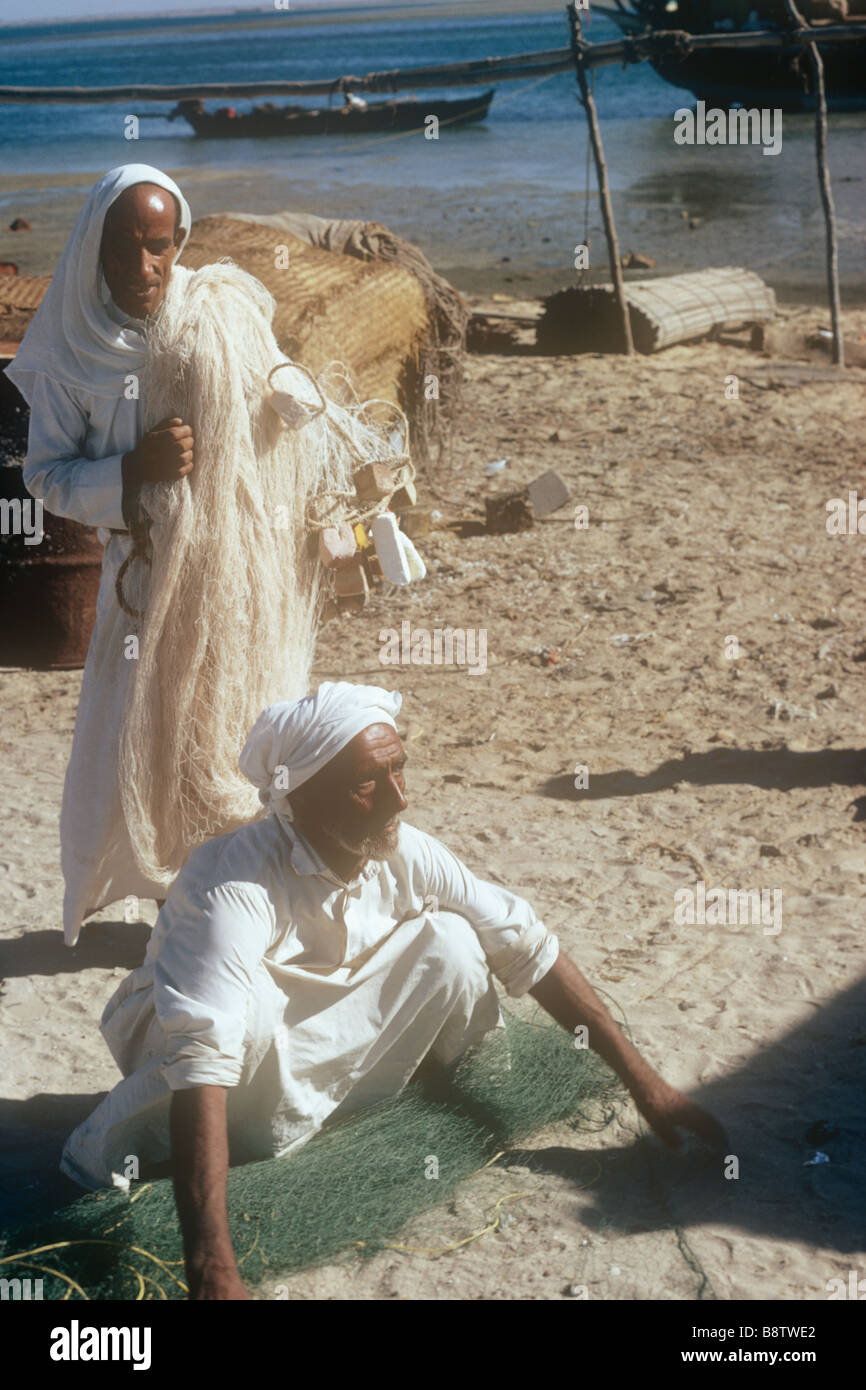 Gulf coast scene with fishermen Ajman, Arabia 1975 Stock Photo