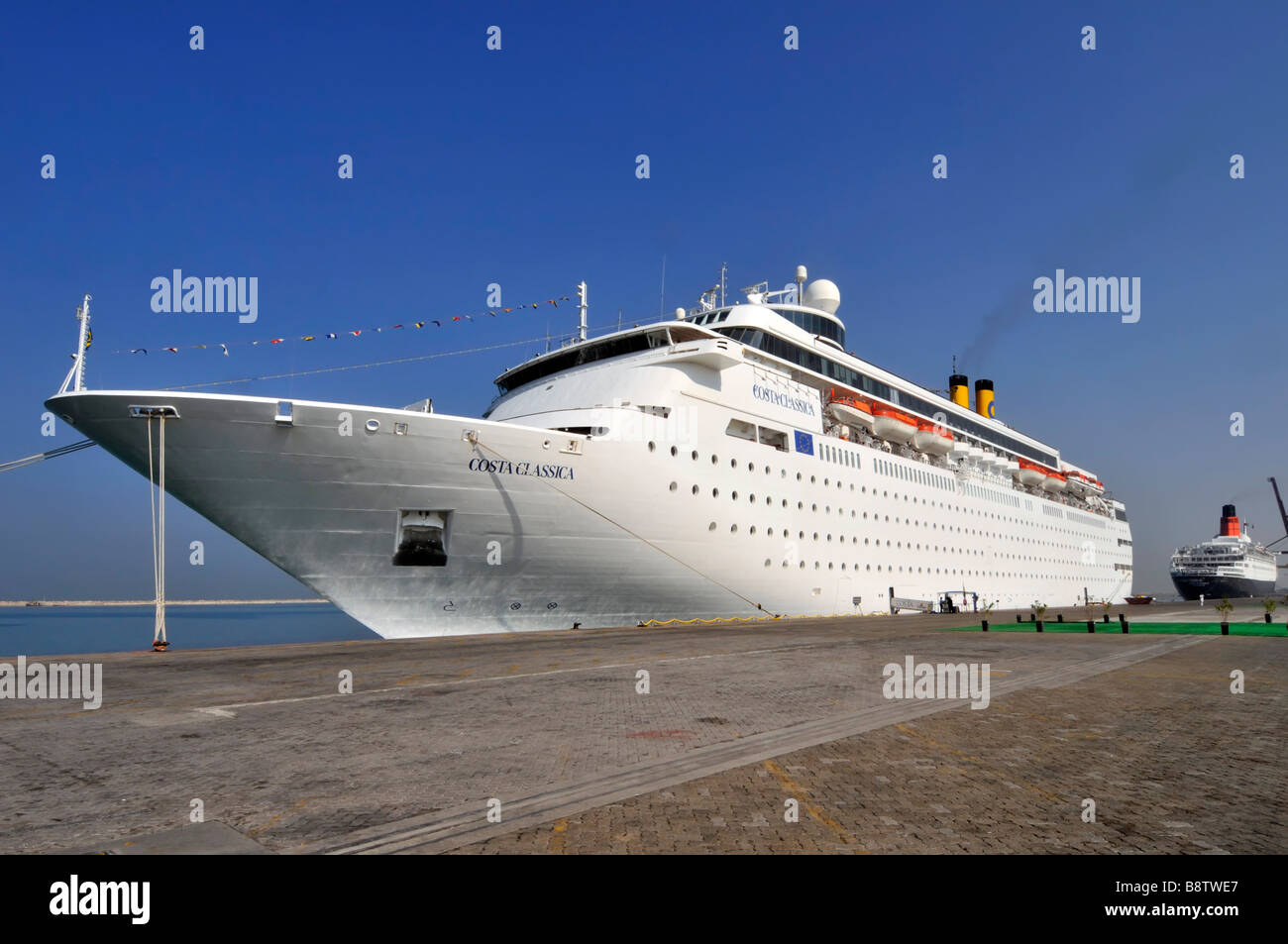 Dubai Costa cruise liner moored at Port Rashid with Queen Elizabeth 2nd liner beyond Stock Photo
