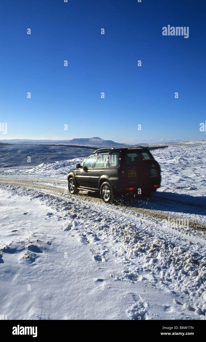 four wheel drive vehicle travelling through heavy winter snow on