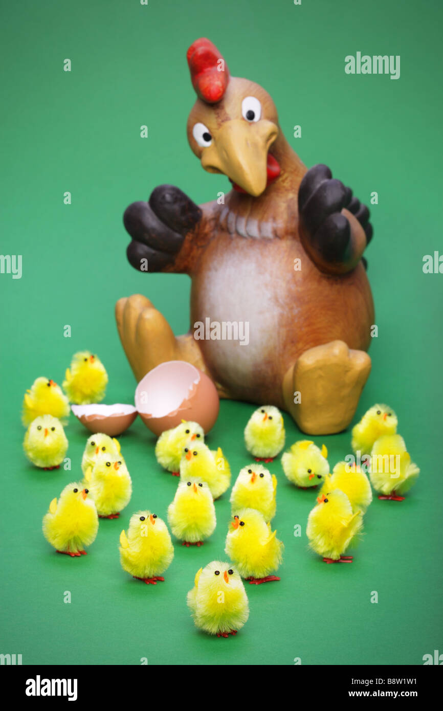 Lots of little toy chicks and a shocked parent focus is on the little guy at the front Stock Photo