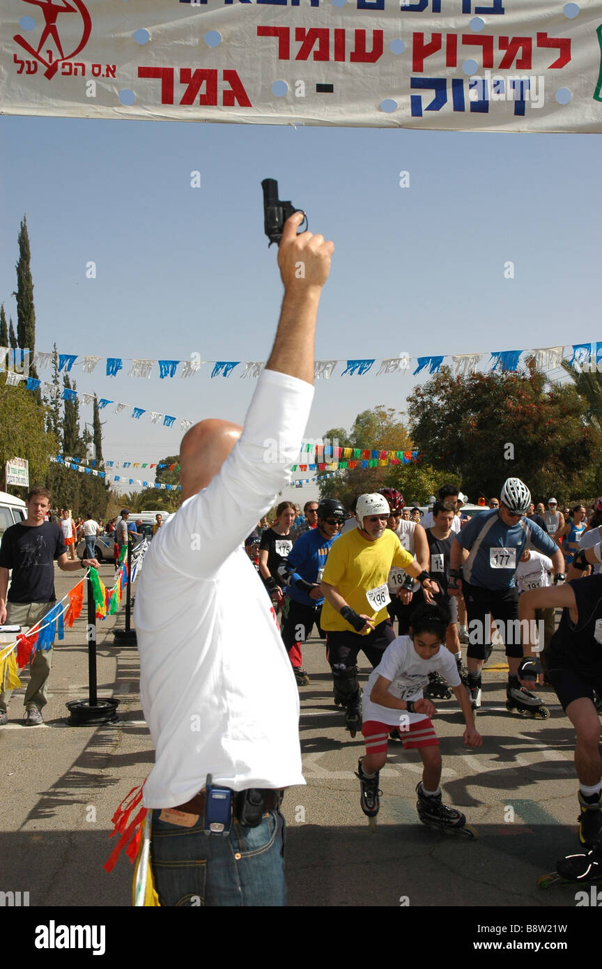Man with Starter Pistol at the Starting Line of a roller blades race