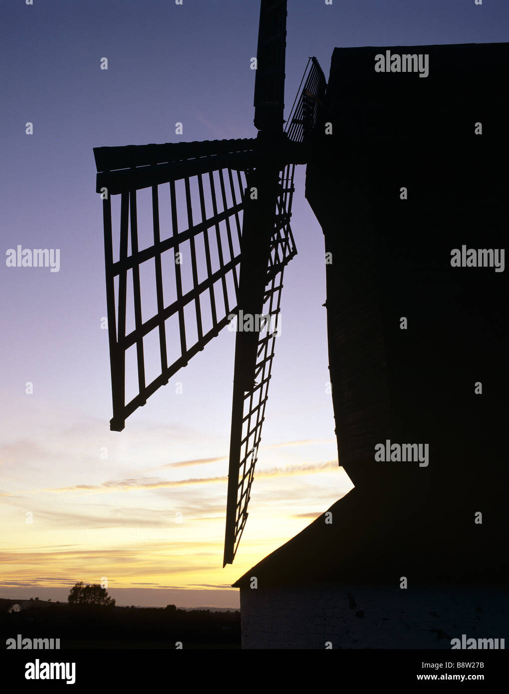 View showing sails of Pitstone Windmill set against sunset Stock Photo