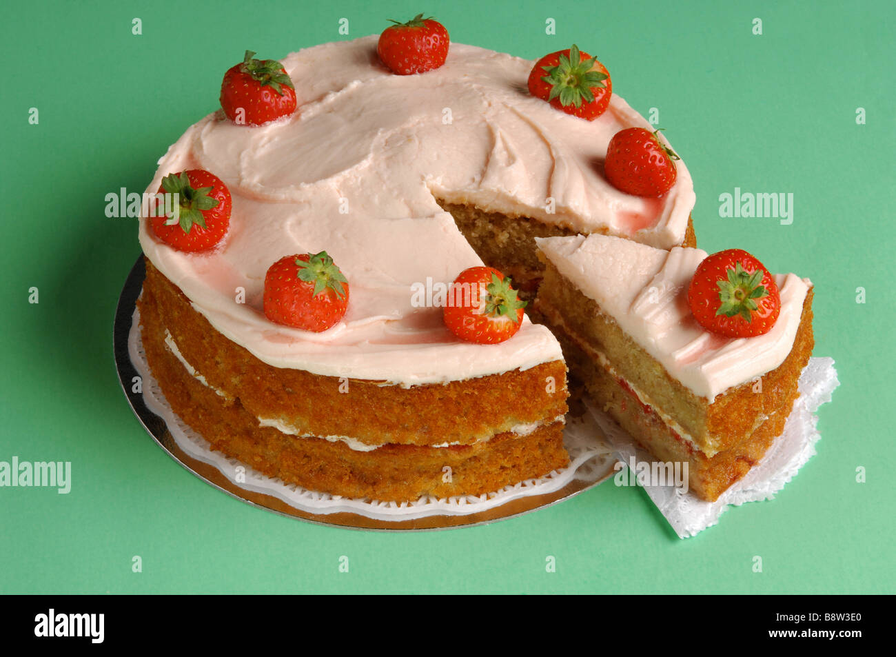 Strawberry sponge cake with slice cut out Stock Photo