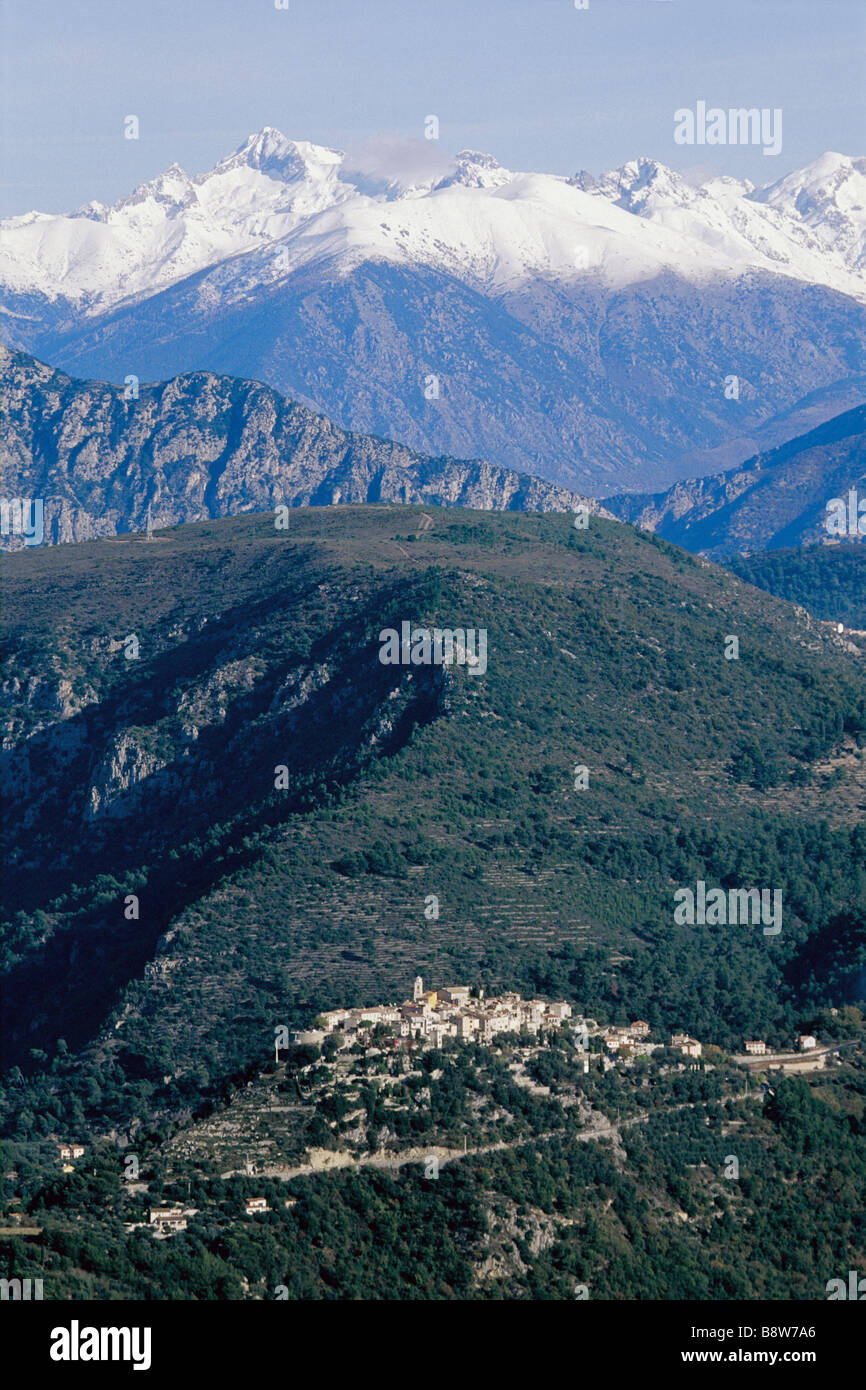 Perched village of La Roquette sur Var with the Mercantour snowed mountain Stock Photo