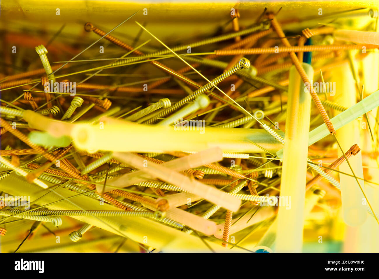 Close up view of open sharps box showing used acupuncture needles Stock