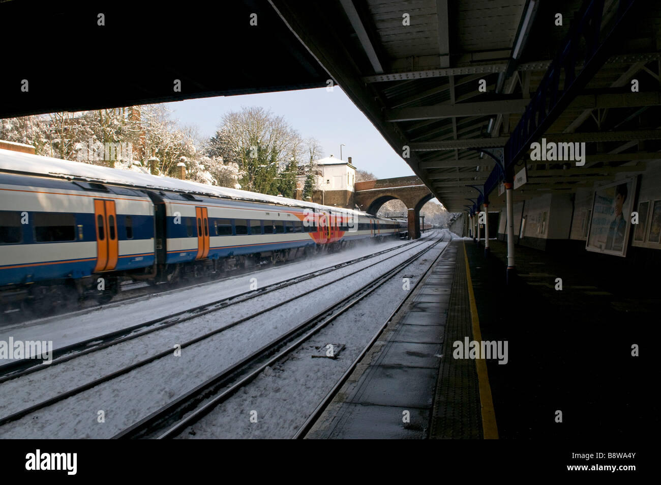 Train rushing by Weybridge railway station on a cold wintery day Stock ...