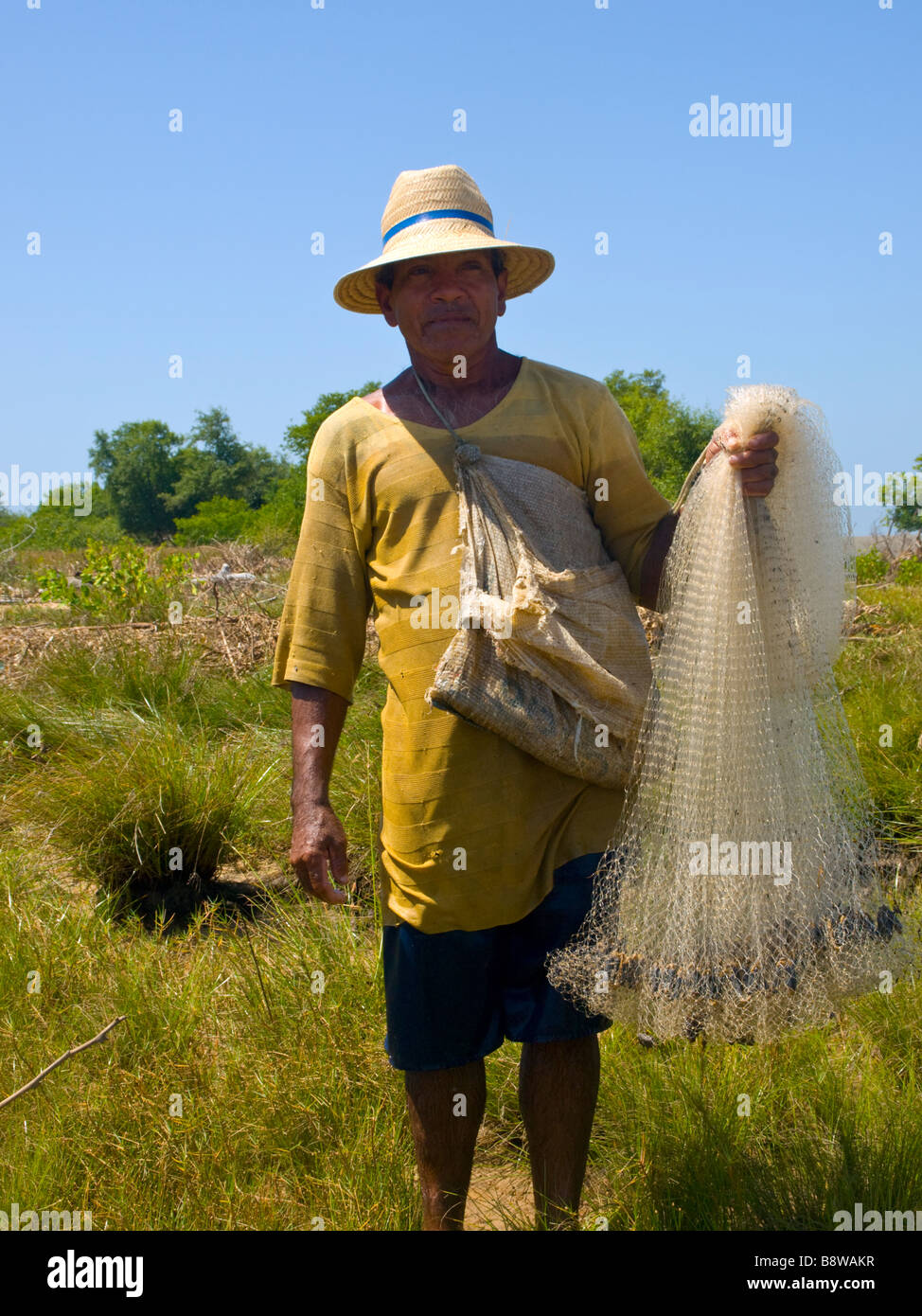 Brazilian fisherman with his net on a fluvial island of the Parnaiba Delta of the Americas, Piaui State, Brazil. Stock Photo