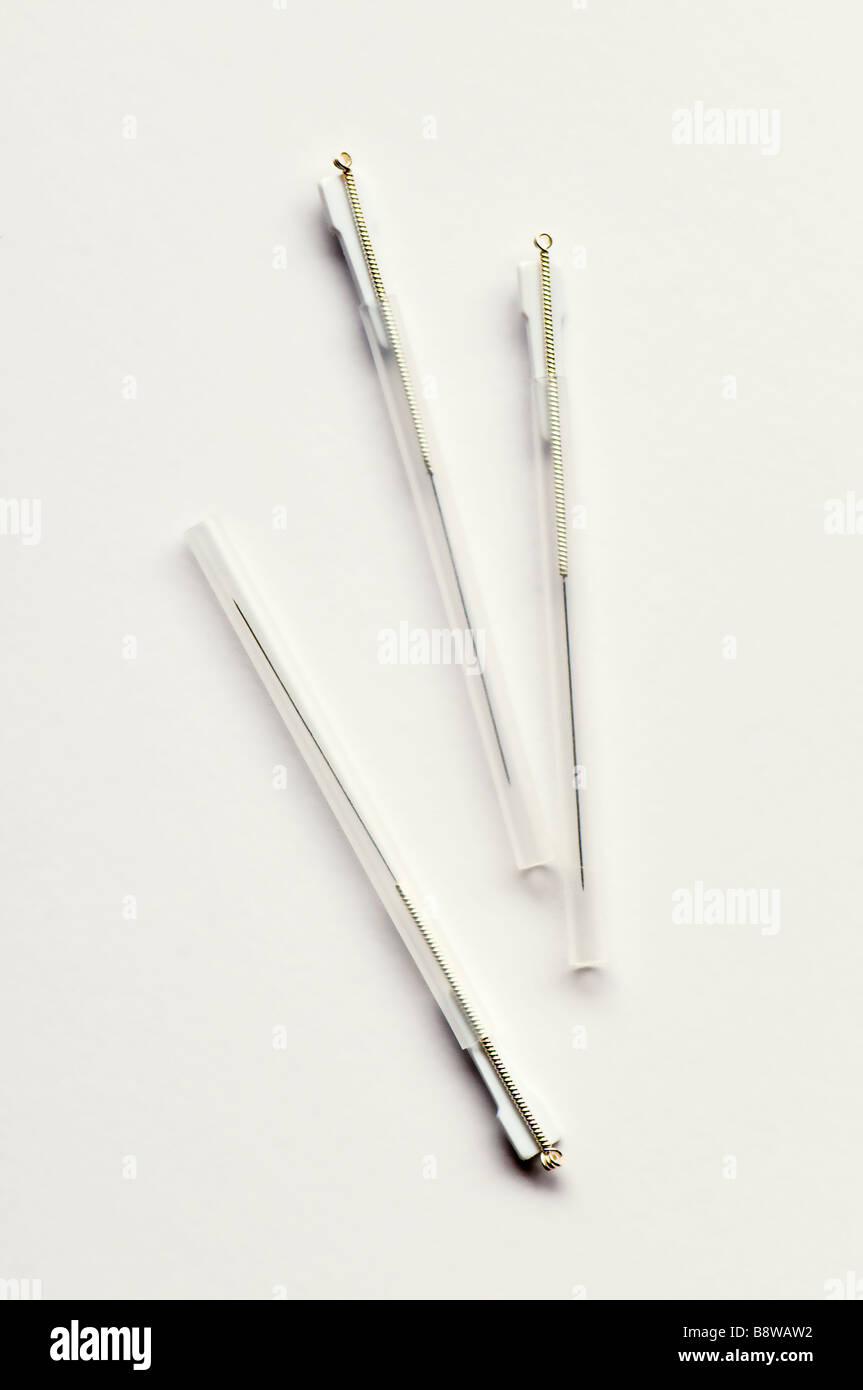 Close up of three 1 inch size acupuncture needles in guide tubes taken