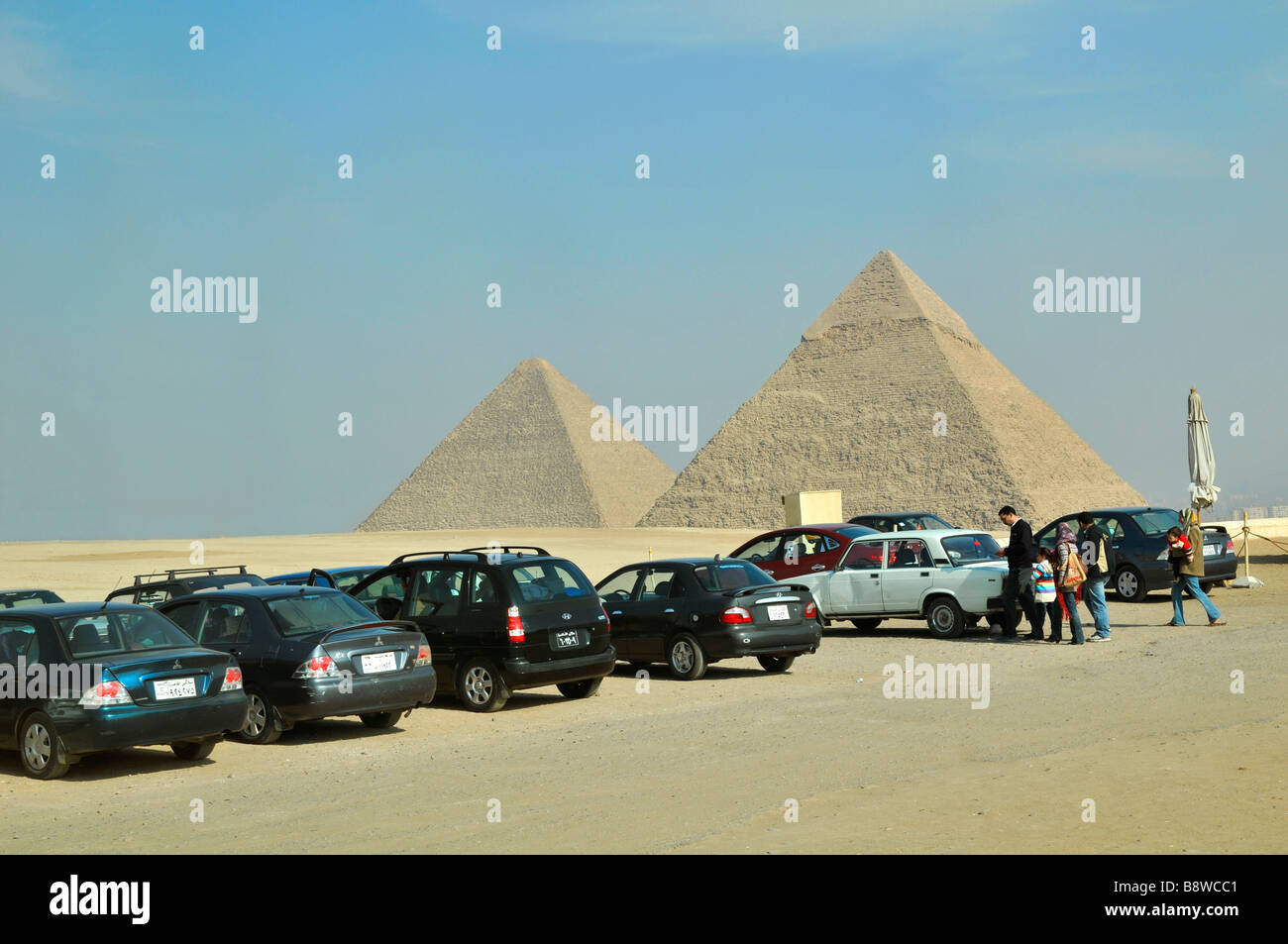 Passenger cars parked by pyramids in Giza Egypt Stock Photo Alamy